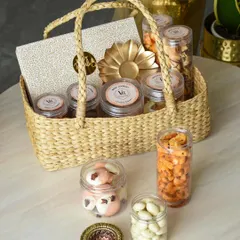 A beautiful and rustic Diwali gift basket, filled with jars of assorted treats and a festive diya. This option is perfect for a warm, traditional gift that feels both personal and premium.
