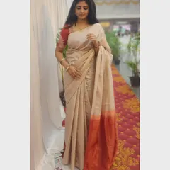 Dressed in a beautiful cream and red saree. I love embracing traditional wear for special occasions.