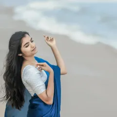 A close-up of the soft, natural makeup for this beach photoshoot. The look is minimal and fresh, designed to enhance her features without looking heavy, perfect for natural light photography.