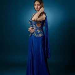 A direct, confident pose showcasing the beautiful floral embroidery on the jacket and the matching choker.