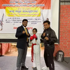 Here I am with Sara, who won Gold at the Under 17 District Level Championship. It's my honor to coach these strong young women and watch them become champions.