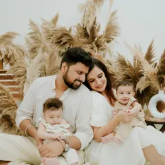 A beautiful family of four. This portrait captures the love and joy of life with twins, set against a stylish and modern pampas grass backdrop.