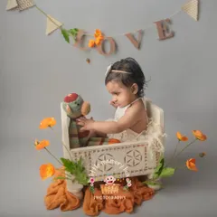 Six months is such a fun age. This little one is enjoying a playful moment with a stuffed toy in one of my prop beds. The "LOVE" banner adds a sweet touch to the setup.