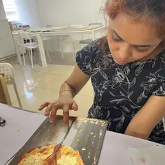 Carefully pressing down the gold foil to ensure it adheres perfectly. It's a delicate process that yields stunning results.