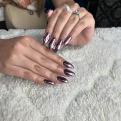 A beautiful metallic purple chrome finish on almond-shaped nails. This look is sleek, modern, and incredibly reflective.