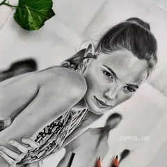 Another angle of the Gal Gadot portrait, showing the finished work next to my pencils. This view highlights the subtle shading and highlights that bring the drawing to life.