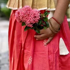 The beauty is in the details. This close-up of my Nila set shows the delicate Jamdani motifs on the peach cotton skirt and the traditional Kasavu border on the peplum top. It’s a celebration of Indian handloom craft.