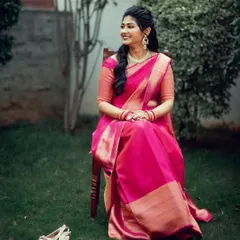 A beautiful bride-to-be, sitting in a garden and smiling, all set for her engagement ceremony.