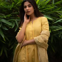 A classic portrait using the soft, even light of an overcast day. The subject's traditional attire against the simple green background creates a timeless and elegant look.