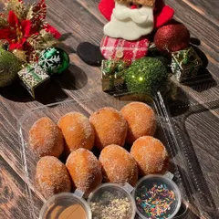 The perfect midweek treat. This mini donut box includes fluffy, eggless donuts with three delicious dipping sauces: chocolate, caramel, and sprinkles.