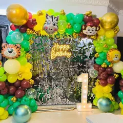 A closer look at the jungle-themed birthday decoration, highlighting the animal characters and the shimmering effect of the sequin wall.