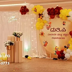 This is an example of the beautiful themed decor we can arrange for a first birthday, including custom banners in Kannada like this one reading 'Happy First Birthday'.