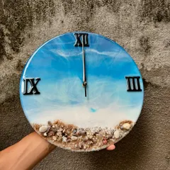 Here’s one of my most popular creations, the ocean-themed resin wall clock. I use real sand and shells to create a miniature beach scene, and the layered resin waves give it a realistic 3D look. It's a beautiful piece of functional art for any home.