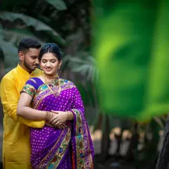 A romantic pre-wedding portrait of a couple in a lush, green setting, capturing a quiet moment of togetherness.