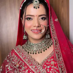 The quintessential Indian bride in a classic red lehenga. For this look, I focused on creating a radiant base, defined eyes, and a timeless elegance that complements the traditional attire perfectly.