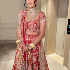 A complete bridal look, ready for the ceremony. The soft waves in her hair add a touch of modern romance to the traditional attire.