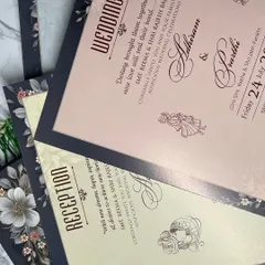 The complete suite for a modern, luxe wedding. The inserts continue the theme with a mix of blush pink and cream, beautifully framed by the dark floral border.