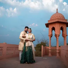 Using the beautiful sky as a backdrop, this portrait on the palace terrace has a majestic feel. The couple's pose is elegant and timeless, fitting the royal theme.