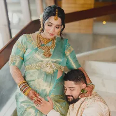 A tender moment captured forever. The makeup is soft and natural, ensuring the focus remains on the love and anticipation of this beautiful couple.