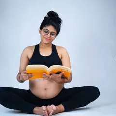 A quiet moment of preparation. This mom-to-be is captured reading a book, a simple and sweet portrait that speaks to the journey of motherhood.