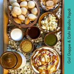 A beautiful chaat platter from our summer feast menu. This spread includes everything you need for Gol Gappe and Dahi Bhalla Papdi, laid out with all the chutneys and toppings.