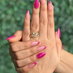 Pretty in pink! This vibrant pink design features a modern French tip style with glitter details for a fun and feminine look.