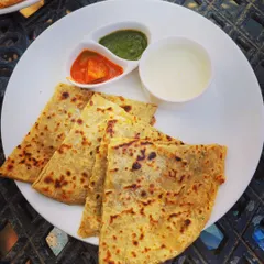 Nothing beats a plate of hot, homemade parathas. Here I have a variety of stuffed flatbreads including Aloo, Gobi, and Paneer paratha, served with fresh dahi, spicy mango achar, and green chutney.