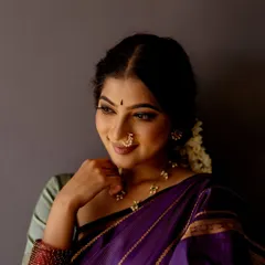 A close-up portrait inspired by the ethereal beauty of Ravi Varma's paintings. The soft lighting, traditional nose ring, and thoughtful expression aim to capture a timeless, artistic quality.