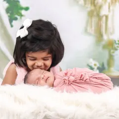 The love between siblings is priceless. This tender moment shows an older sister welcoming her new baby sibling, a memory this family will cherish forever. I guide siblings to interact naturally for authentic, heartwarming shots.