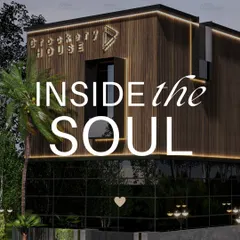 This commercial building, the Crockery House, features a modern facade with a mix of wood-look slats and dark glass. The design is meant to be striking and contemporary, reflecting the soul of the brand within.