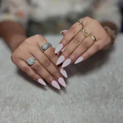 Simple and chic. These long, stiletto-shaped extensions are finished with a solid, matte-like pale pink polish for a clean and modern style.