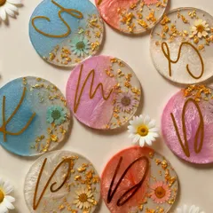 These custom resin coasters are one of our most loved wedding favors. We personalize them with initials, dried flowers, and gold flakes for a gift your guests will cherish and use long after the celebration.