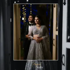 A classic portrait of the couple looking towards their future together. The dramatic lighting and formal wear create a sense of timeless elegance and sophistication.