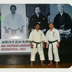 With my respected teacher, Shihan Kousaku Yokota, in front of portraits of karate masters. His teachings are the lifeblood of our association, and I am honored to be his student and the representative for Asai India.