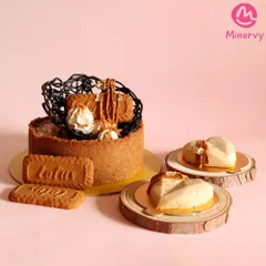 A full display of my Biscoff cheesecake offerings. You can see the larger cake perfect for a party, alongside the individual heart-shaped mini cheesecakes that are great for gifting or as part of a dessert table.