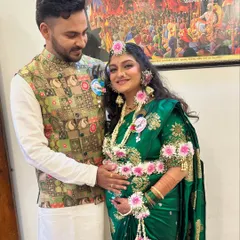 The happy couple at their baby shower. The mom-to-be is glowing in her green saree and beautiful floral jewelry.