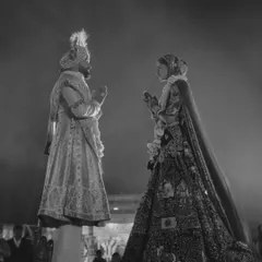 A powerful black and white silhouette of the couple during the varmala ceremony. This artistic shot captures the grandeur and timelessness of the moment as they stand before their loved ones.