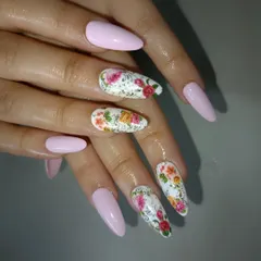 A closer view of the intricate, hand-painted floral accent nails.