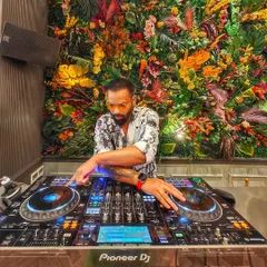 Letting the good vibes roll from behind the console. The floral backdrop at this venue was amazing and added to the overall atmosphere of the party.