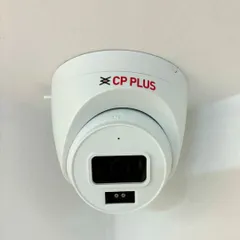 A close-up of the CP Plus IP dome camera installed on the ceiling of the Gurgaon office. Its clean, white housing blends in perfectly with the professional environment.