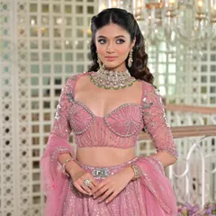 The details of this pink lehenga are exquisite. My draping style ensures the embellished blouse and belted waist are highlighted, creating a structured and flattering silhouette.