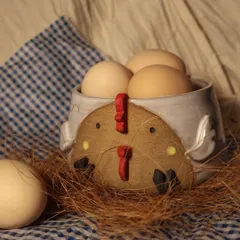 A quirky chicken-themed bowl, perfect for holding eggs or serving a small dish. It adds a touch of farmhouse charm to any kitchen.