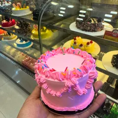 This cute pink mini cake is a perfect example of "mini in size, max in love." Topped with colourful sprinkles, it's a tiny bundle of happiness designed to make your sweet cravings a little prettier.