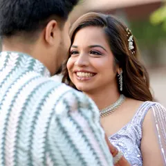 A candid, happy moment between the newly engaged couple. Her makeup is soft and natural, designed to enhance her radiant smile and look beautiful in outdoor, natural lighting.