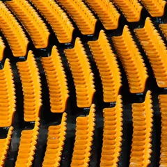 The vibrant yellow seats of the stadium in Gwalior, captured before the crowds arrive. These shots help set the scene for the event.