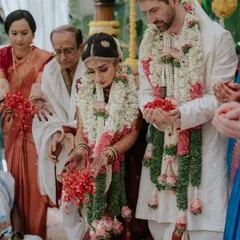 A beautiful moment from a cross-cultural wedding ceremony. The joy and love between the couple are palpable as they participate in the traditional rituals.
