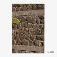 The cyclopean masonry of the Lake Pawana Resort, showcasing large, irregularly shaped stones fitted together. This traditional construction technique gives the walls a powerful, rustic texture that grounds the building in its natural, rugged landscape.
