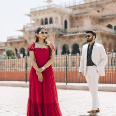 A stylish pose in front of the Albert Hall Museum in Jaipur. The contrast of the modern red dress and white suit against the Indo-Saracenic architecture creates a striking, fashionable pre-wedding photograph.