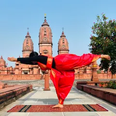 Virabhadrasana III (Warrior III) in front of the temple spires. This pose requires immense focus and strength, reminding us of the power we hold within.