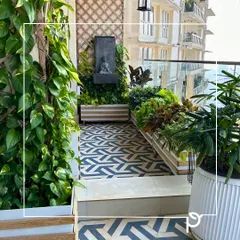Even a compact city balcony can become a lush, private oasis. We transformed this space with a vertical green wall, custom planters, and a mix of foliage and flowering plants, creating a perfect corner for relaxation with a stunning view.